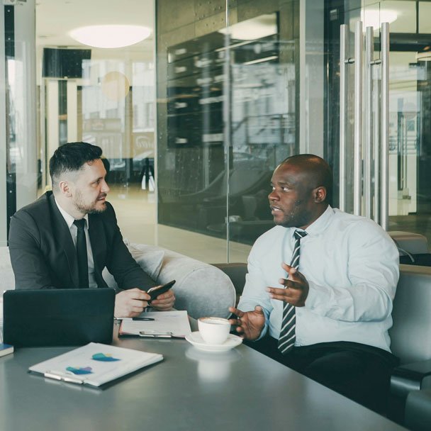 2 Men Having Discussion in Office